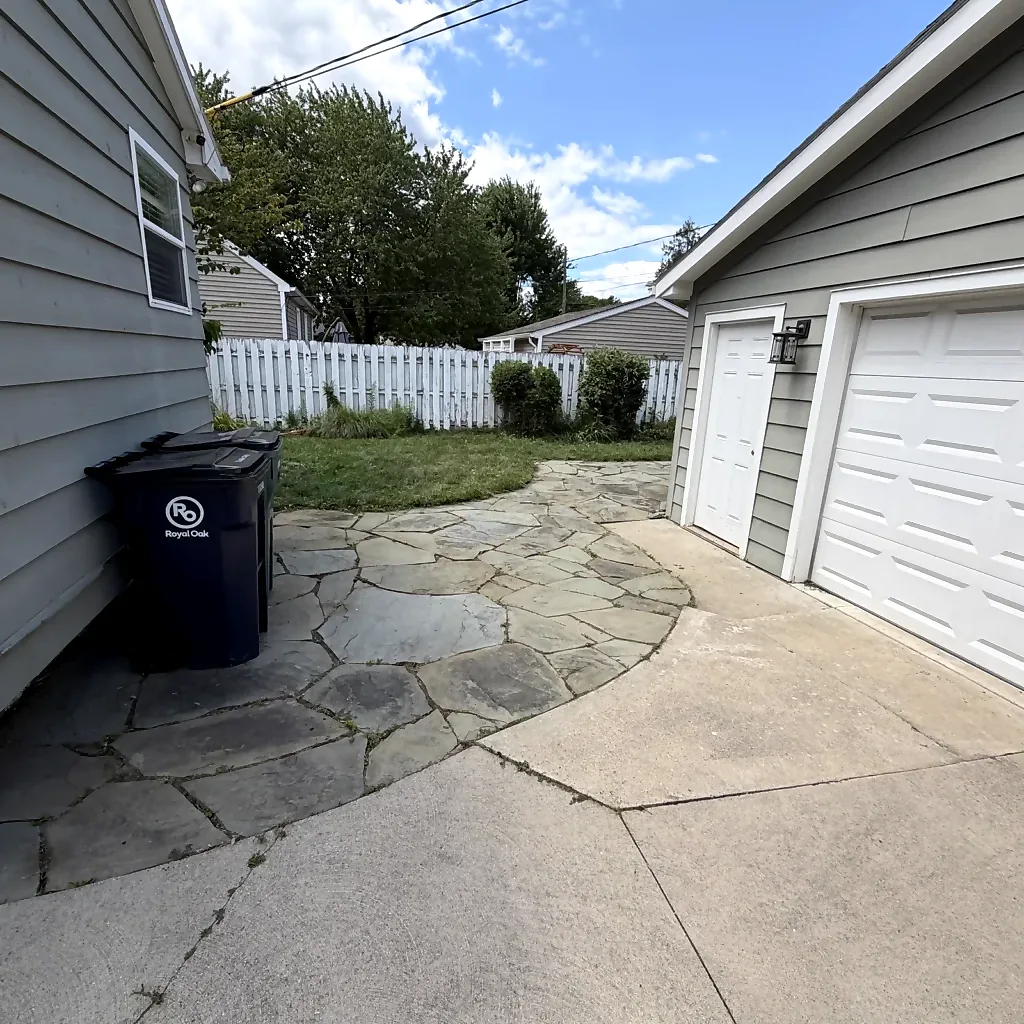 Cleared residential walkway and trimmed surrounding yard in Royal Oak after cleanup